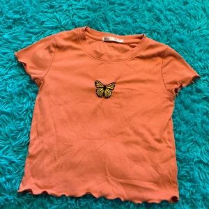 A pink butterfly shirt